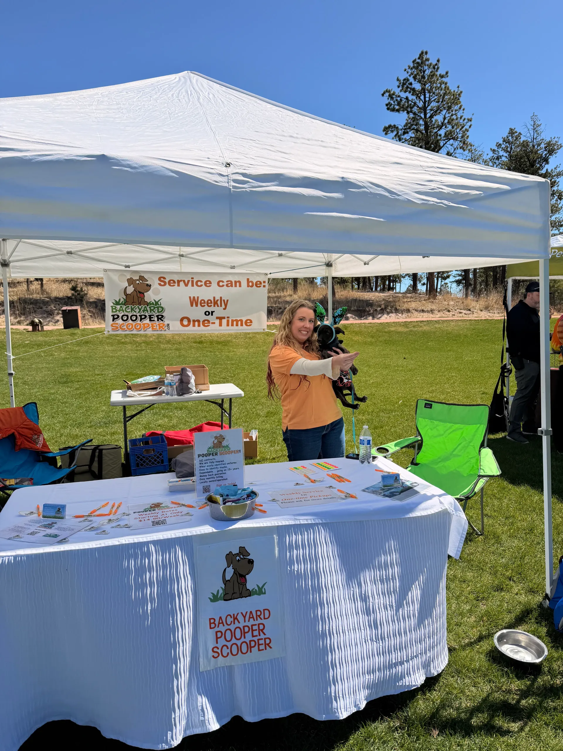 Backyard Pooper Scooper branded booth at a local community event